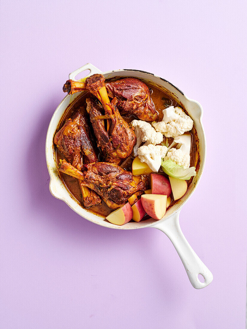 Slow-cooked lamb shank curry with potatoes and cauliflower