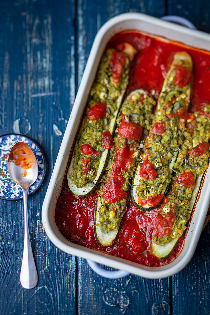 Courgettes with lentil and herb filling in tomato sauce