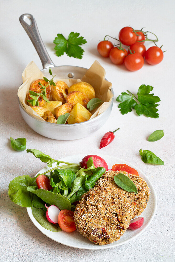 Lentil patties with roast potatoes and salad