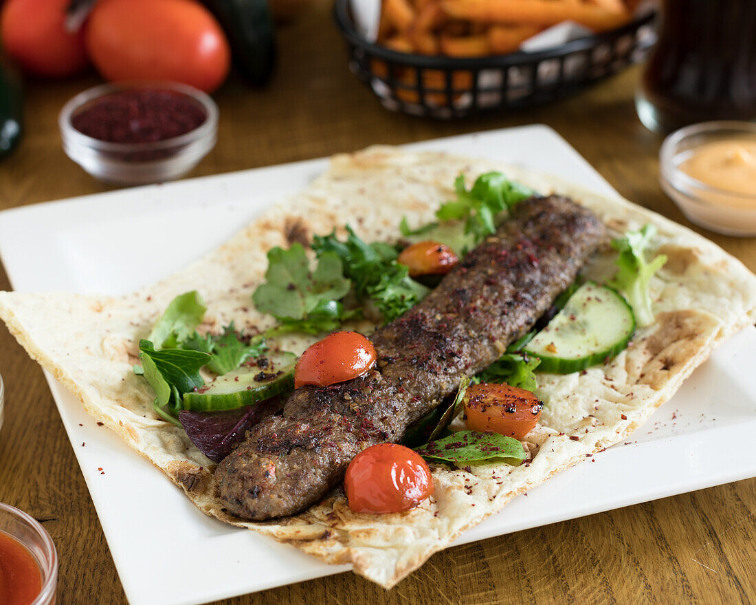 Lebanese kebab roll with vegetables on flatbread