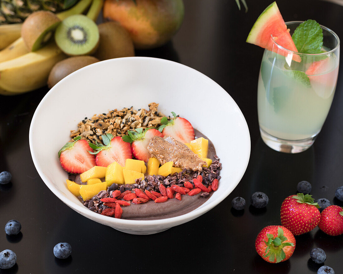 Smoothie bowl with mango, strawberries and goji berries