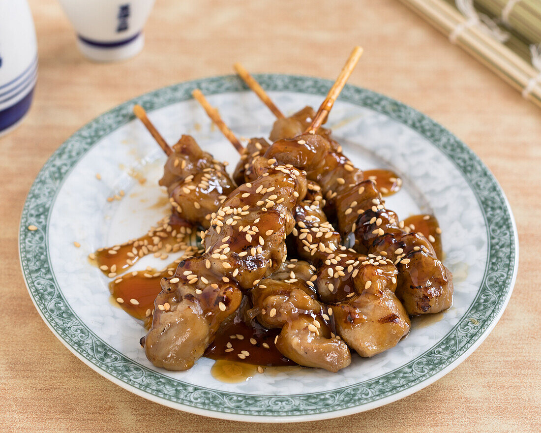 Yakitori skewers with sesame seeds and teriyaki sauce