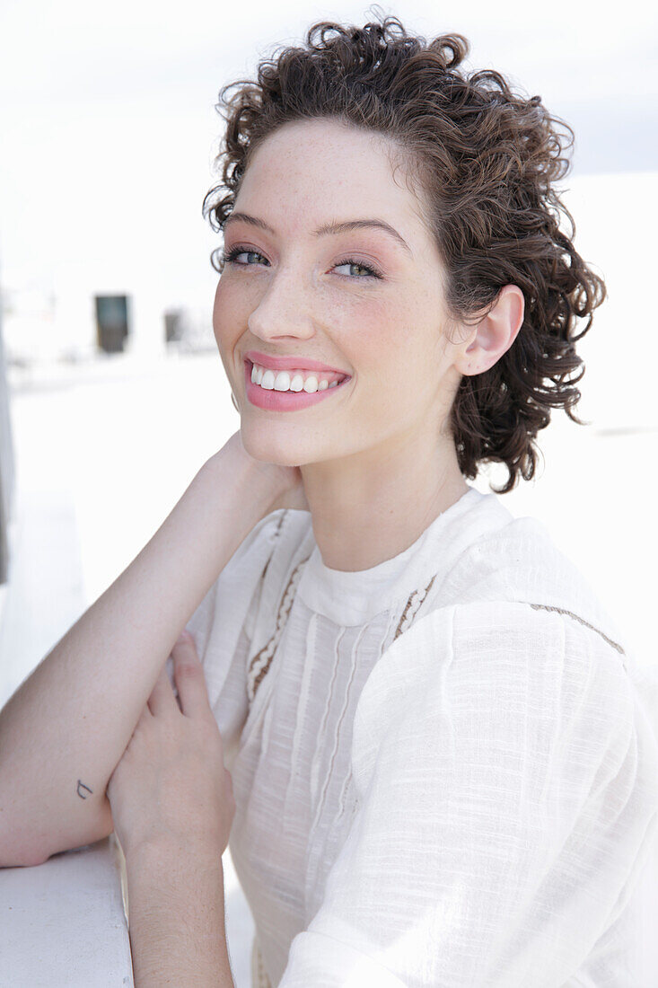 Brunette woman in cream-coloured blouse