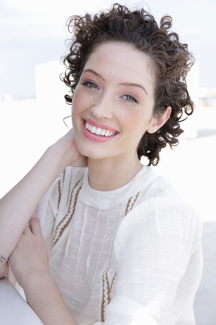 Brunette woman in cream-coloured blouse