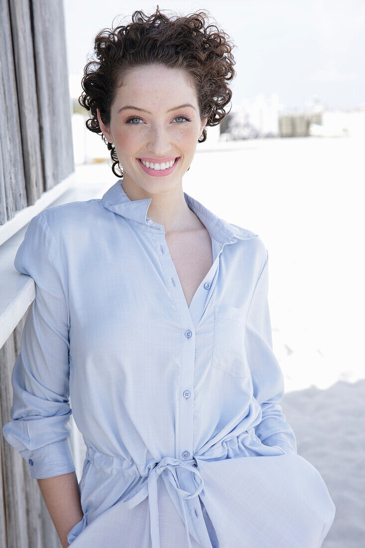 Young woman in light-blue shirt dress