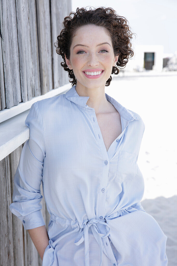 Young woman in light-blue shirt dress