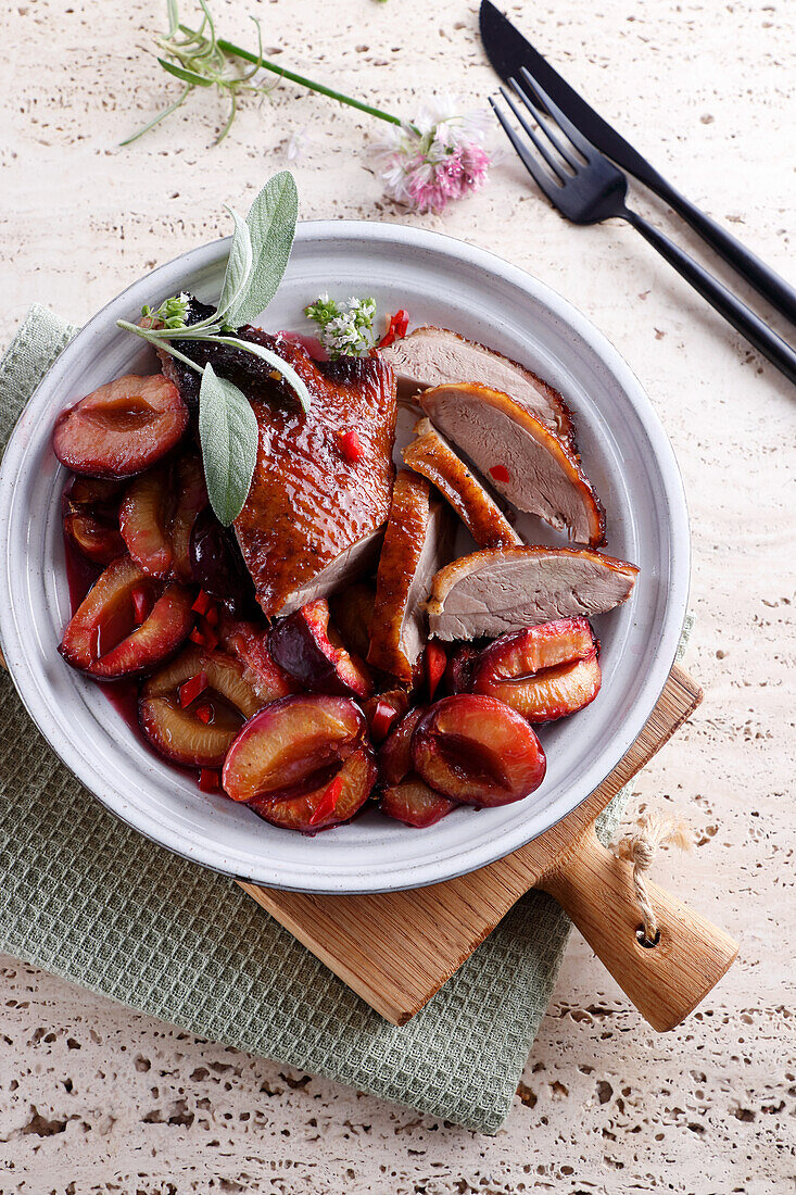 Duck breast with roasted plums and sage