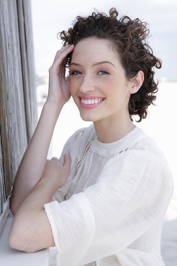 Brunette woman in cream-coloured blouse