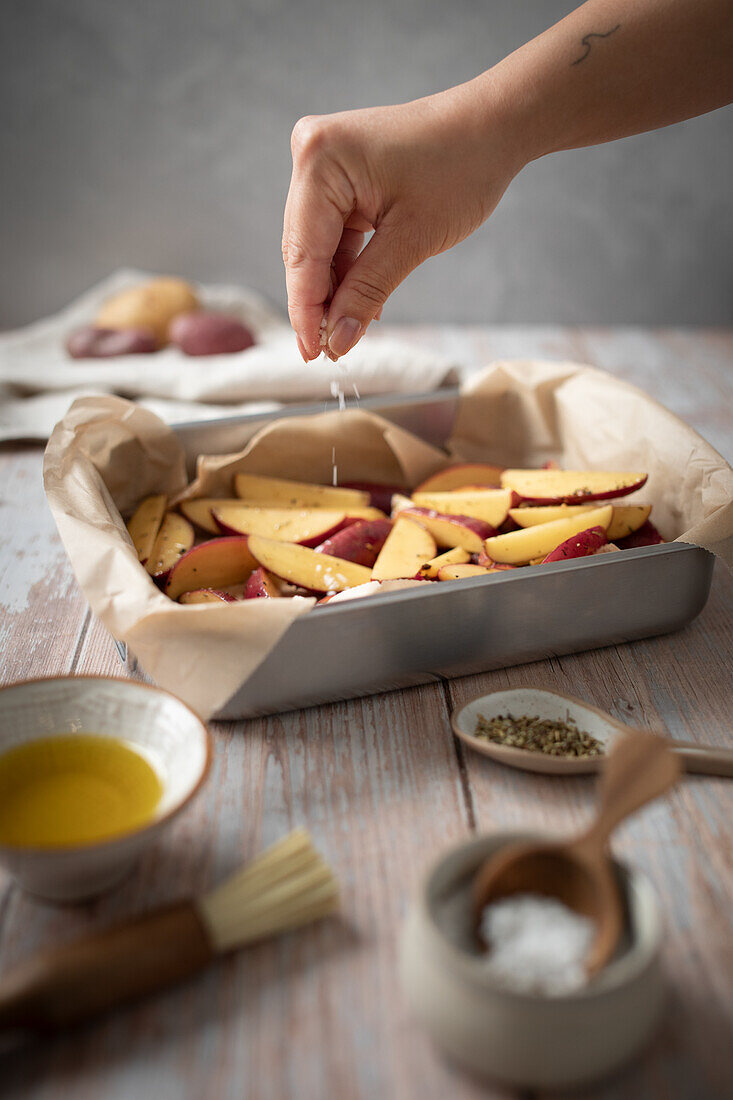 Preparing jacket potatoes with spices and olive oil