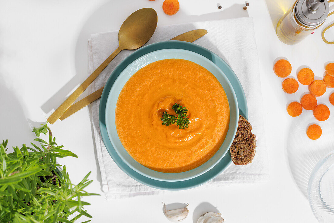 Creamy vegan carrot soup with fresh parsley