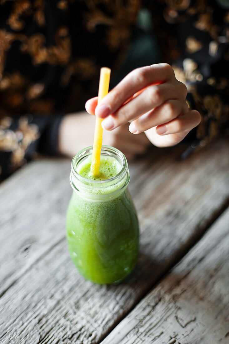 Green smoothie with spinach, kiwi, celery and orange