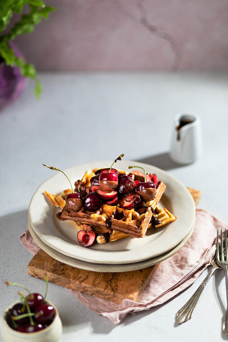 Marble waffles with fresh cherries and chocolate sauce