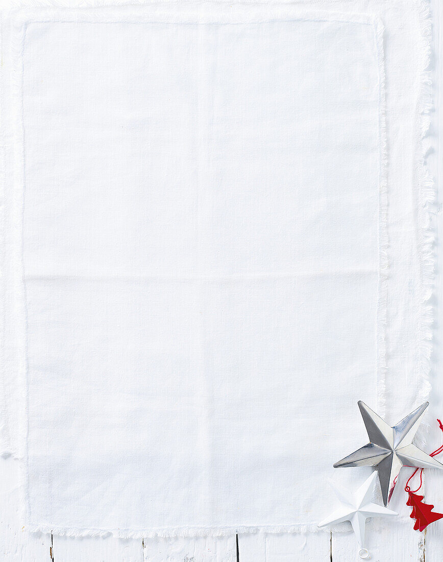 White tablecloth with Christmas decorations on a wooden background