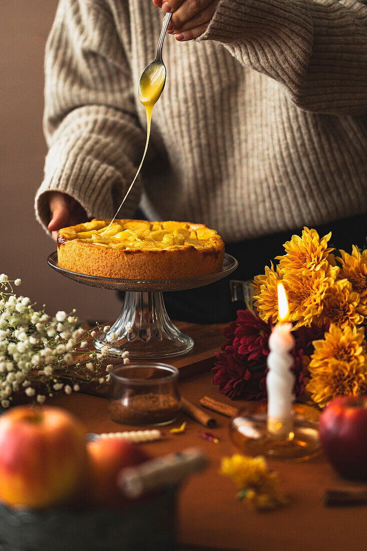 Apple cake with icing and autumnal decoration