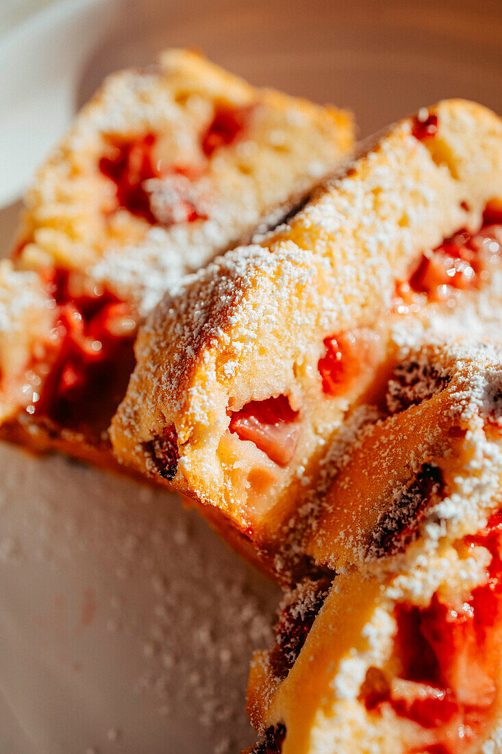 Close-up of strawberry cake with icing sugar