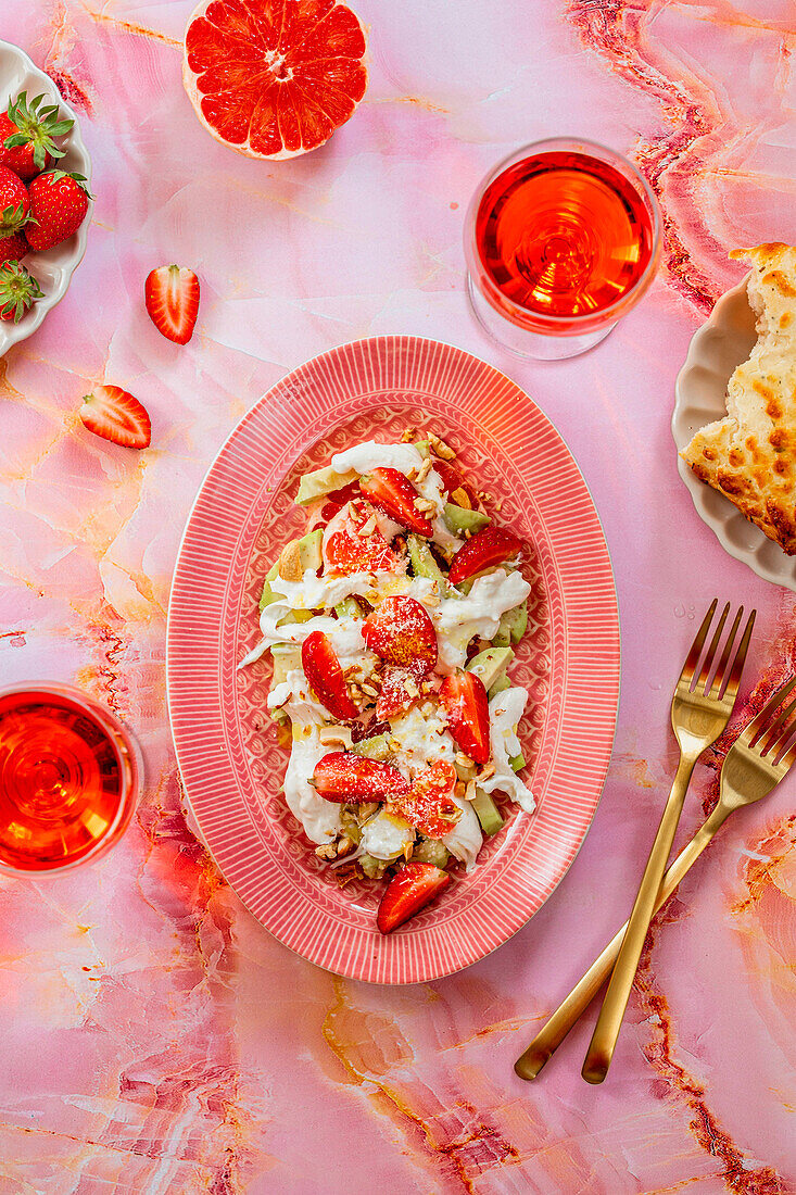 Summer salad with avocado, burrata and strawberries