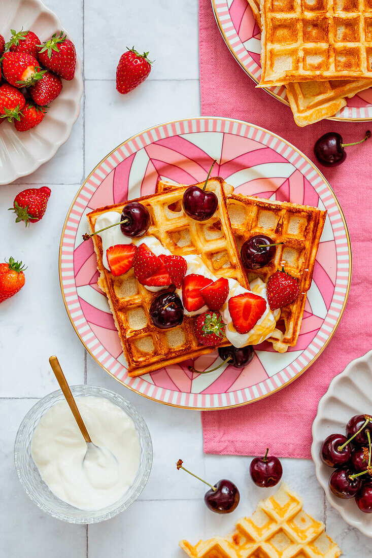 Belgian waffles with cream, strawberries and cherries