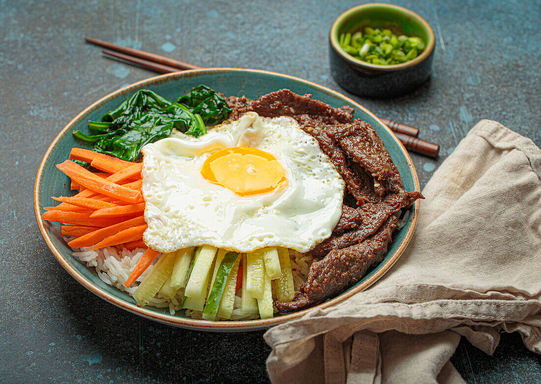 Bibimbap with beef, vegetables and fried egg