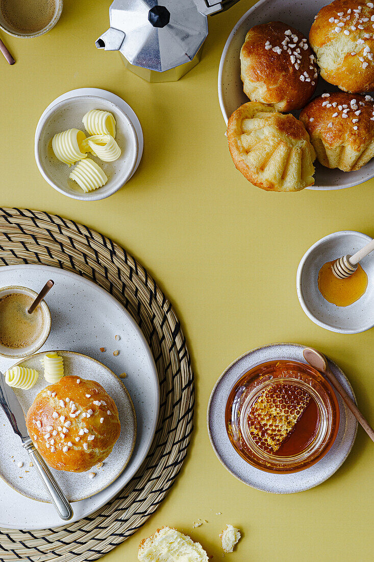 Breakfast with brioche and honey in a jar with honeycomb