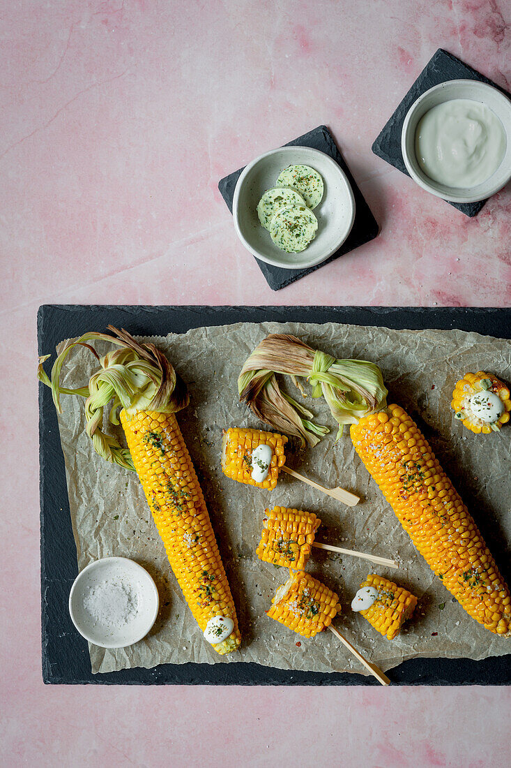 Grilled corn on the cob with herb butter and sour cream