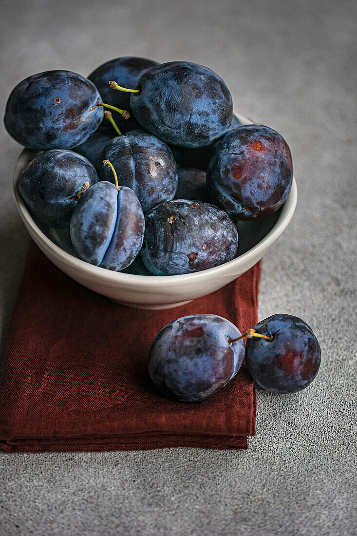 Bowl with fresh, ripe plums