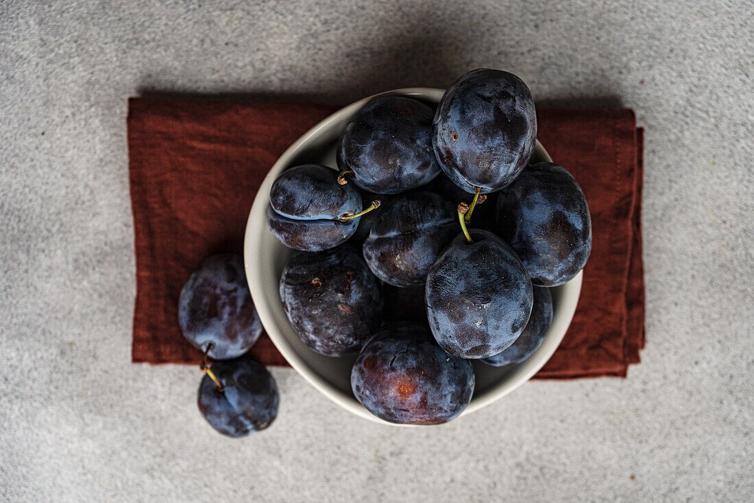 Bowl of fresh, ripe plums