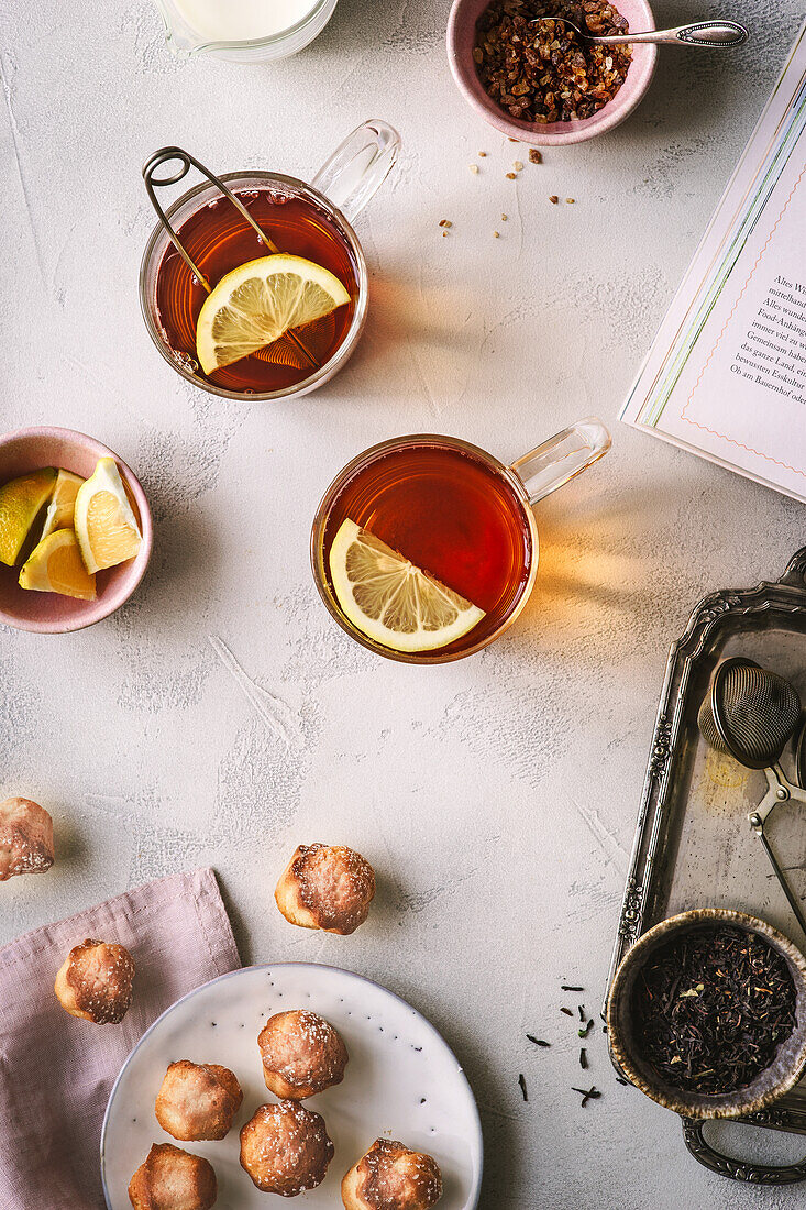 Black tea with lemon slices and biscuits