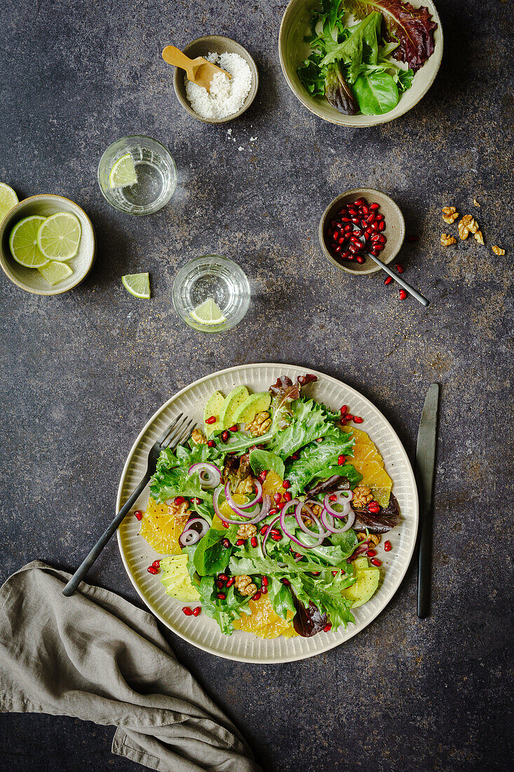 Salad with oranges, walnuts, pomegranate seeds and avocado