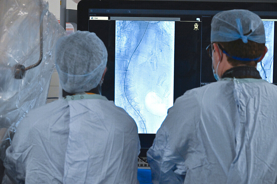 Doctors observing live X-ray during TAVI procedure