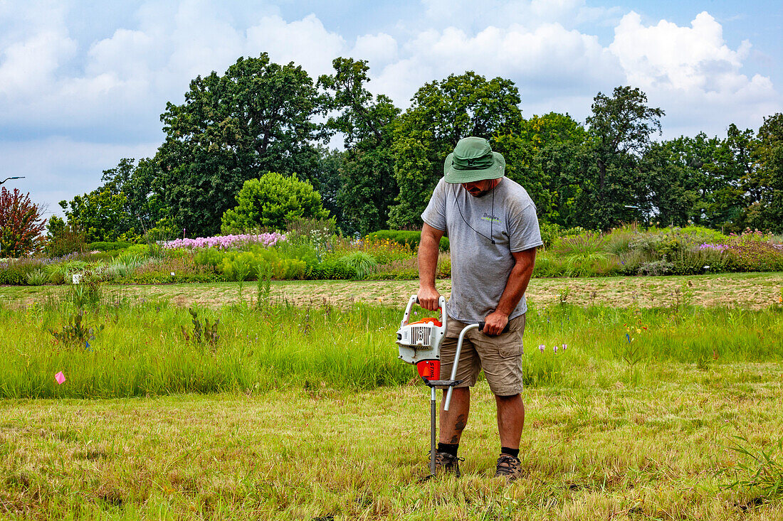 Volunteer using garden tool in park