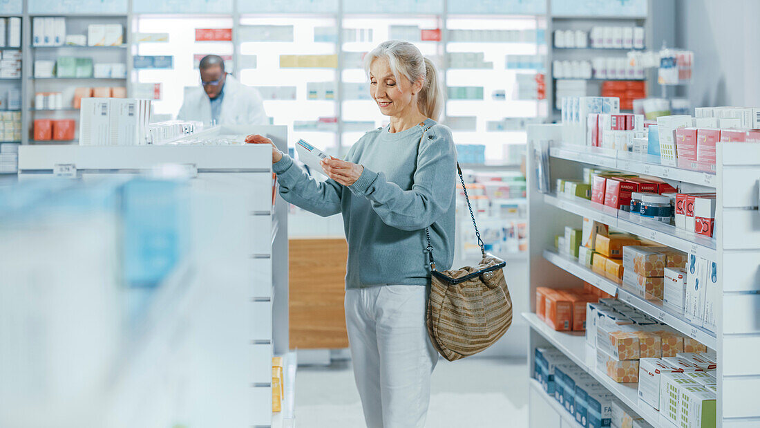 Woman choosing medicine in pharmacy