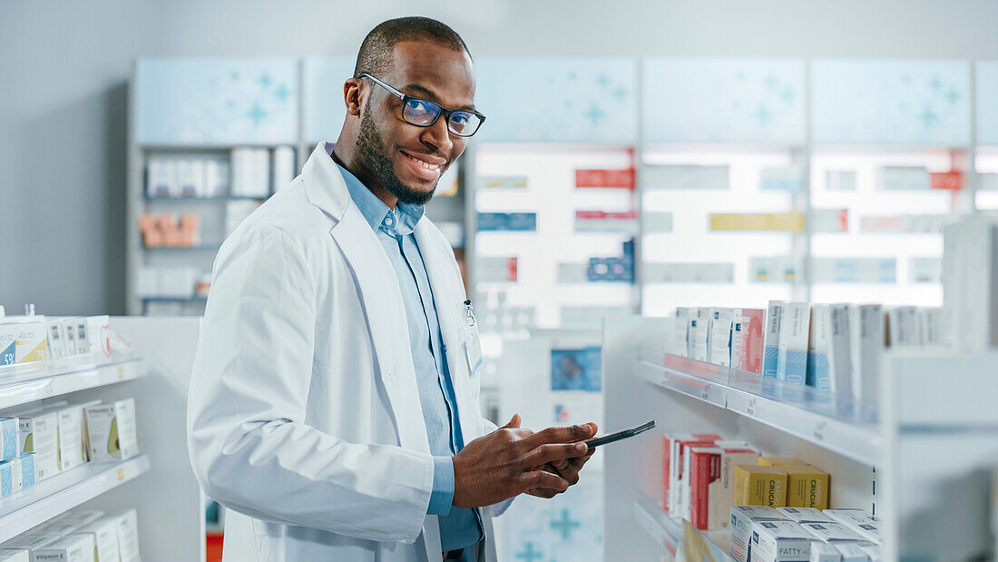 Pharmacist smiling in pharmacy