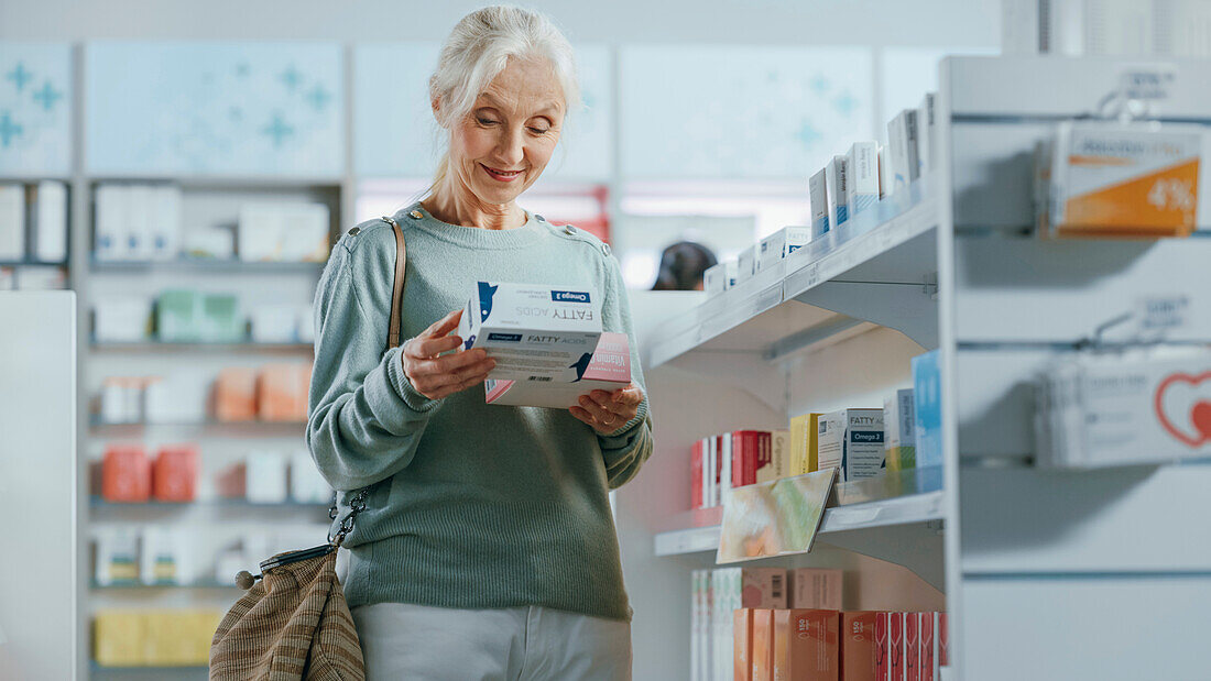 Female customer holding box of medicine