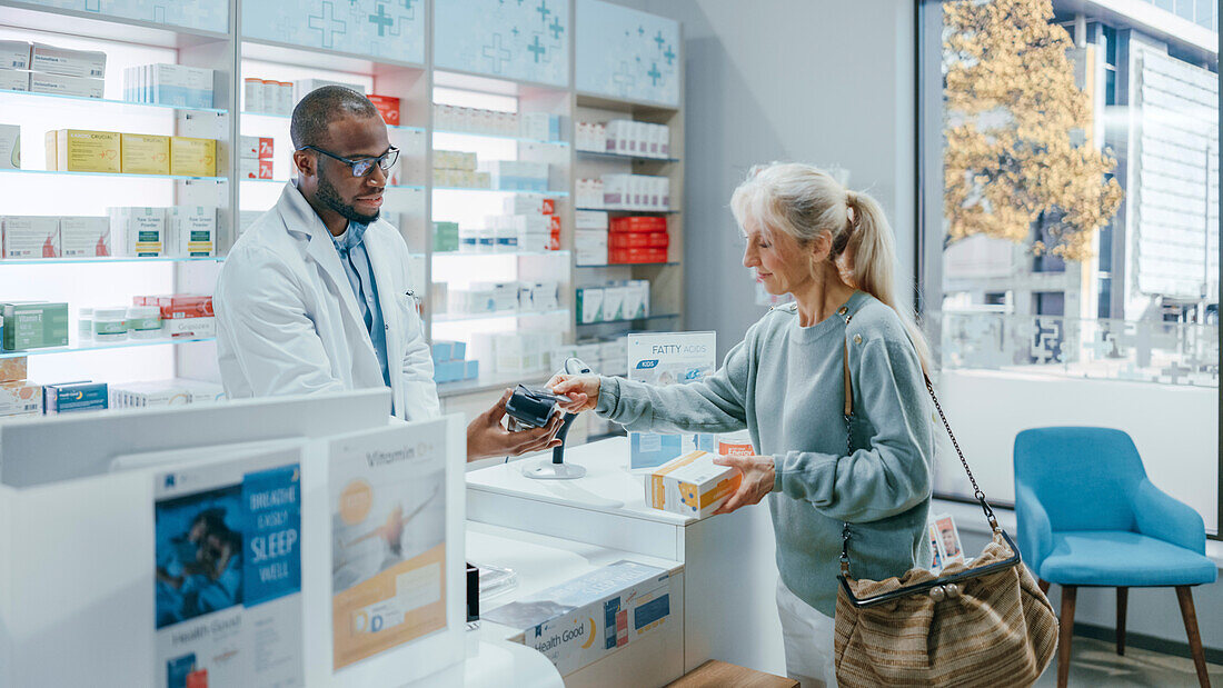 Female customer paying at pharmacy checkout