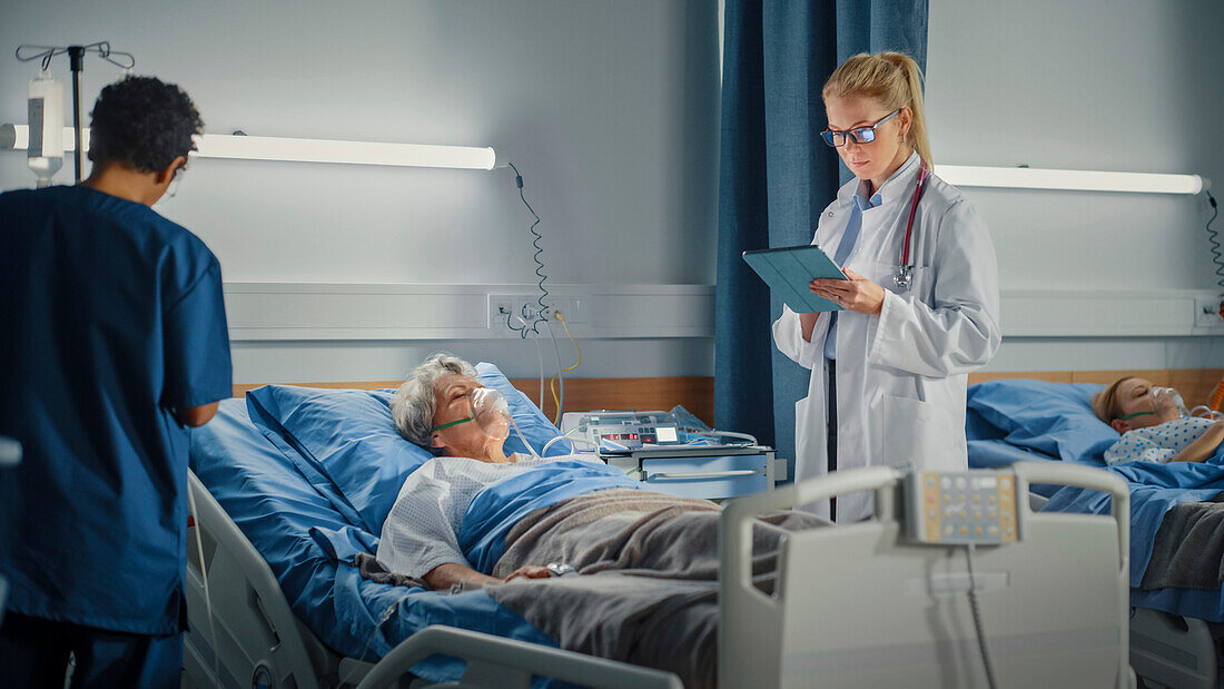 Healthcare professionals checking on elderly patient