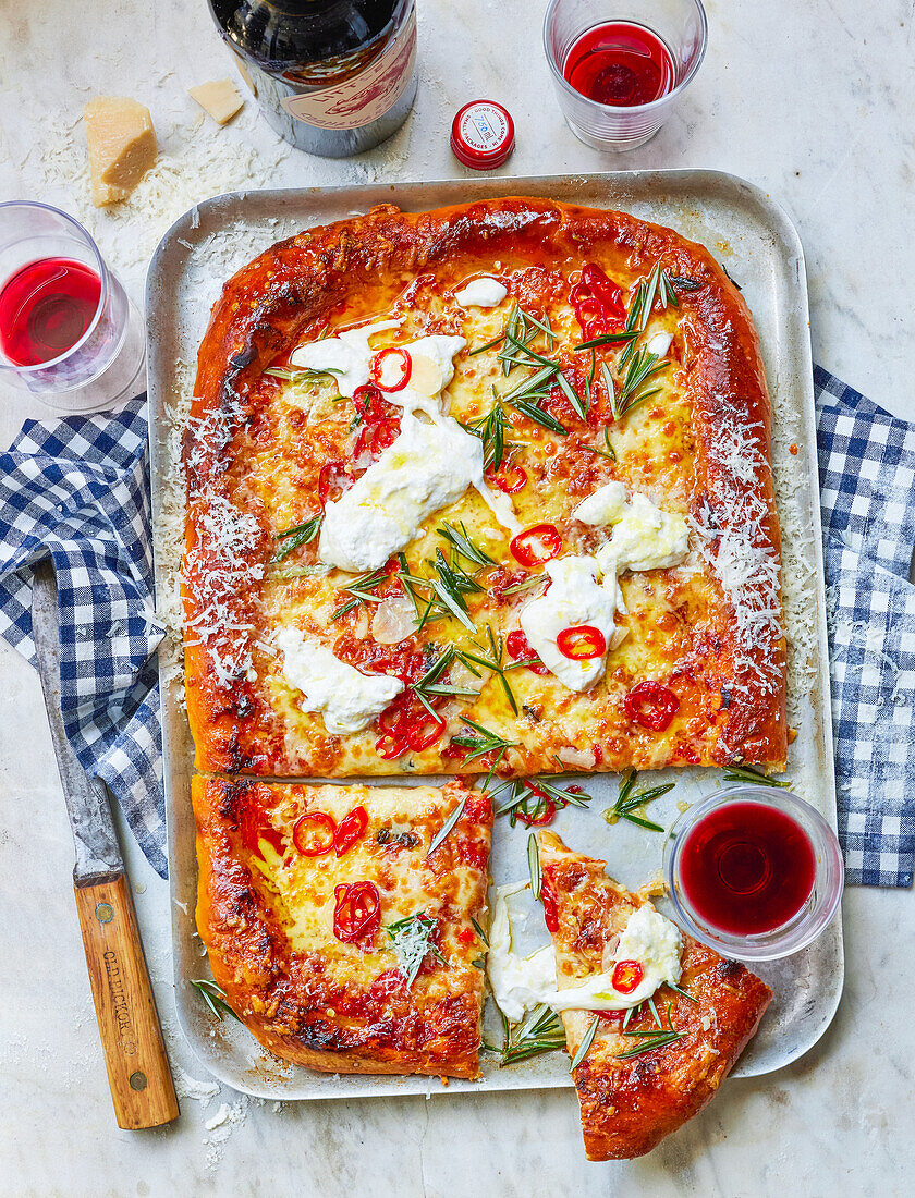 Pizza tray with three types of cheese and pickled chilli peppers