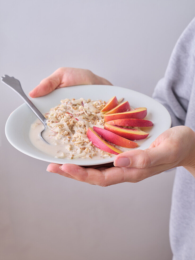 Overnight-Oats mit Nektarinenscheiben und Kokosflocken