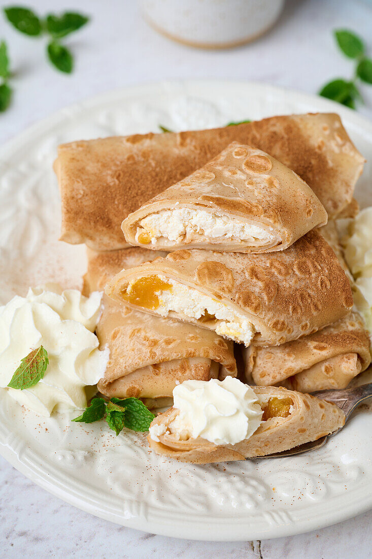 Rolled crepes with cottage cheese and dried apricots