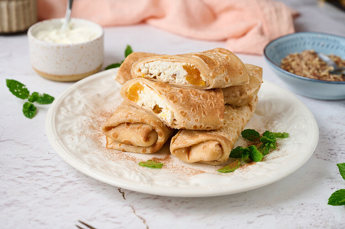 Gerollte Crepes mit Hüttenkäse und getrockneten Aprikosen