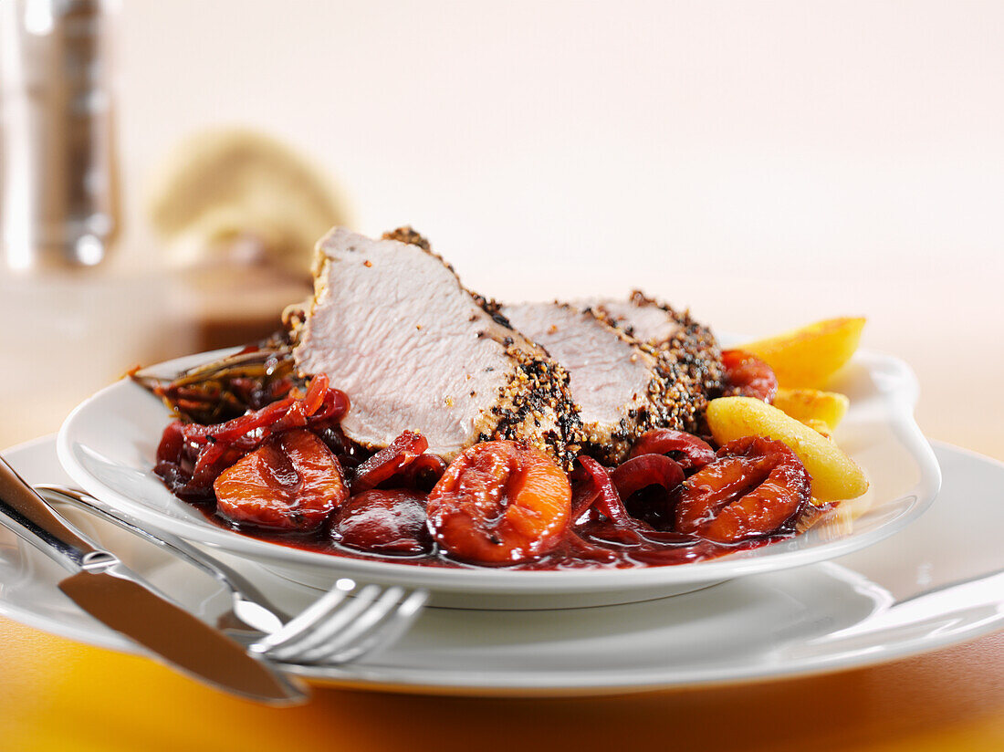 Pepper-crusted pork fillet with cinnamon and plum sauce