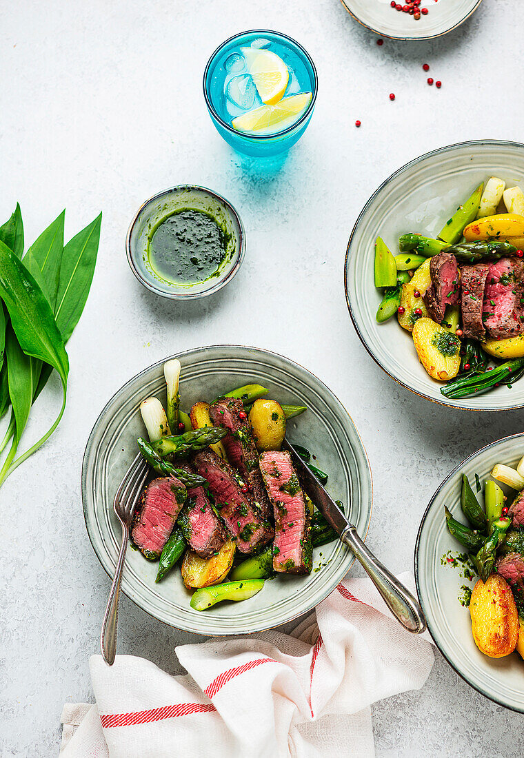 Beef steak with wild garlic oil and spring vegetables