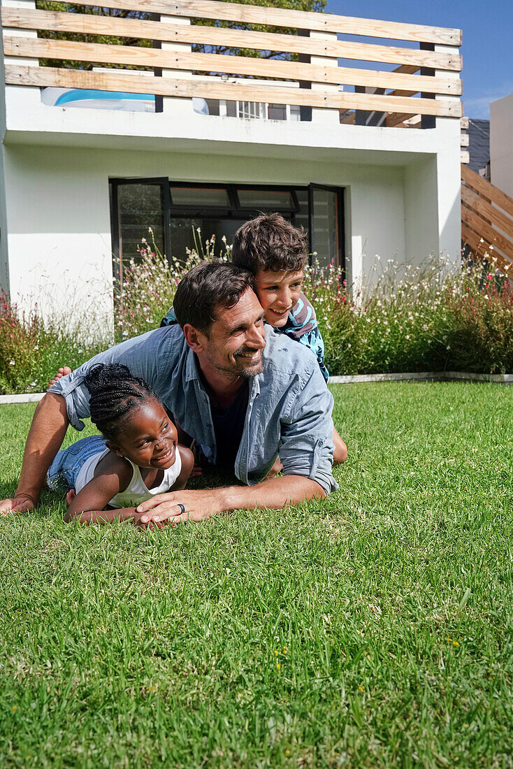 Father with children playing in backyard