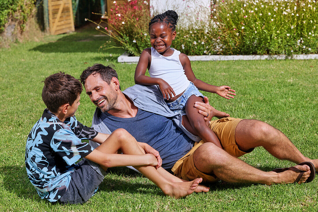 Father with children playing in backyard