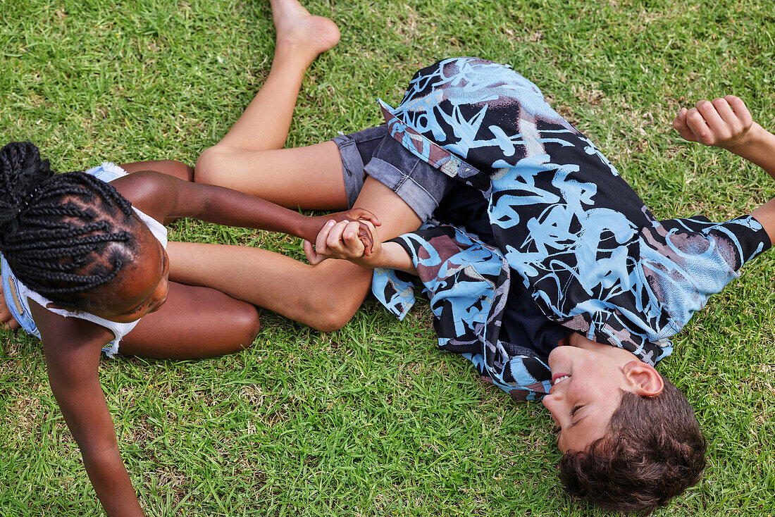 Brother and sister playing in backyard