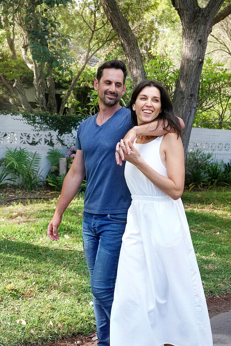 Smiling couple walking on street