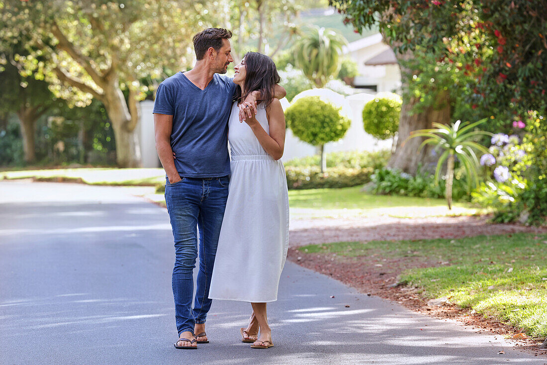 Smiling couple walking on street