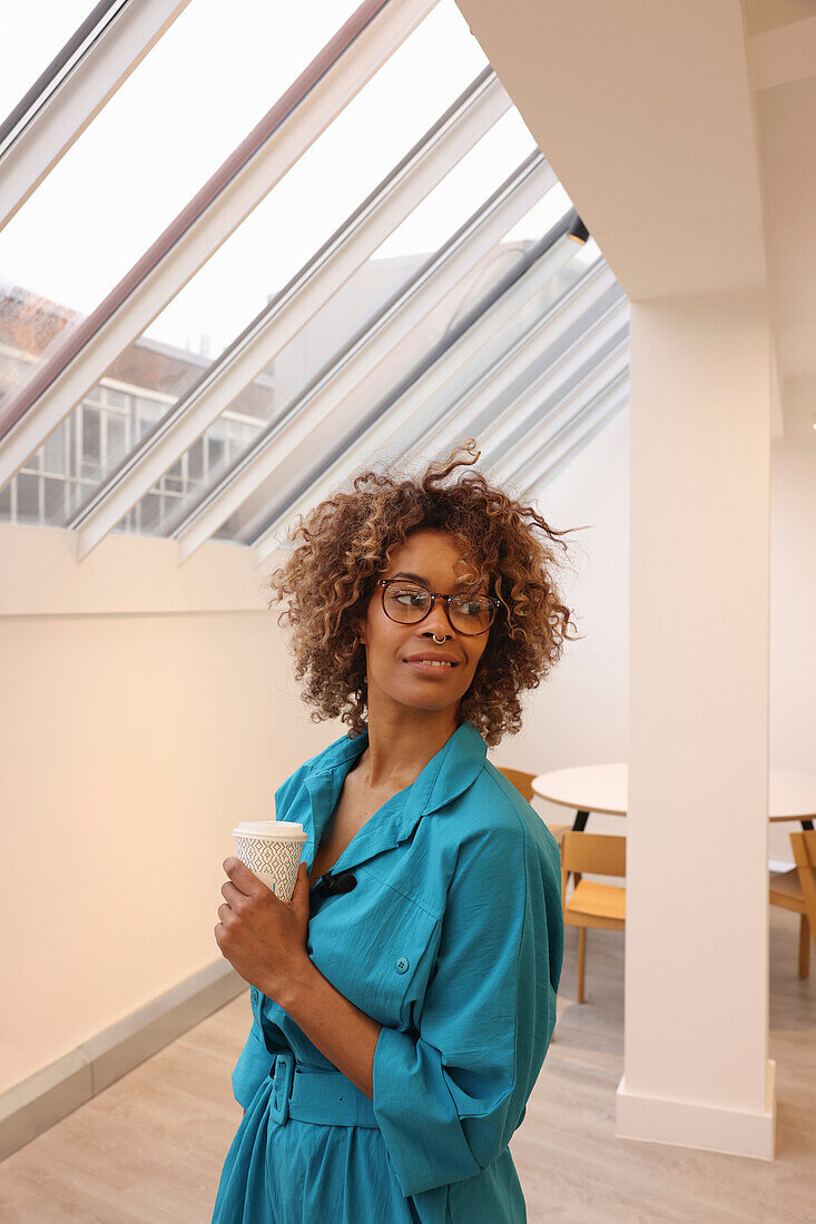 Smiling woman standing in creative studio