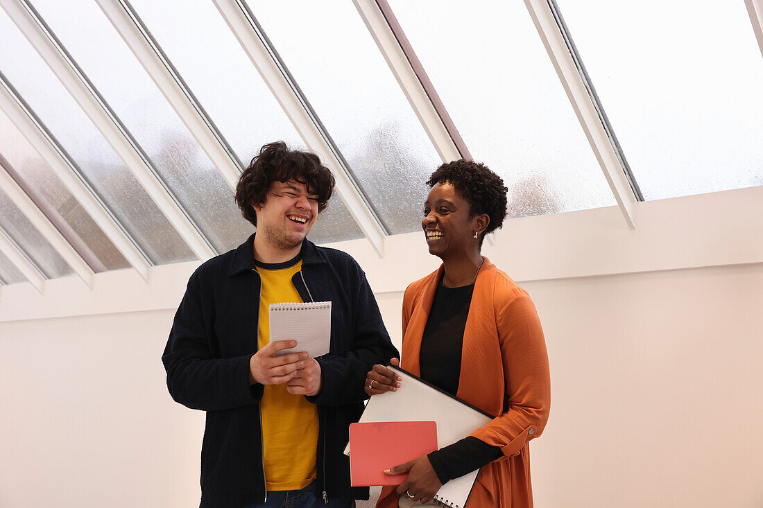 Smiling creative workers talking in studio