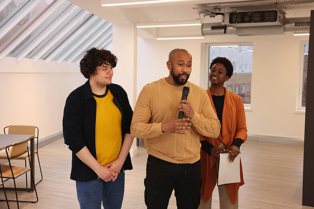 Smiling creative team having presentation in studio