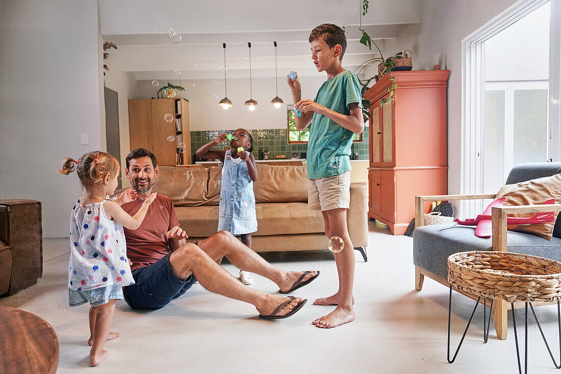 Father with children playing with bubbles